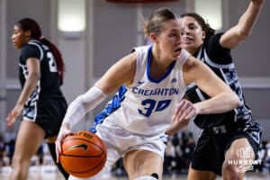 Creighton Bluejay guard Morgan Maly (30) drives to the basket against Georgetown Hoya guard Kelsey Ransom (1) in the second quarter during a college basketball game Saturday, February 15, 2025 in Omaha, Nebraska. Photo by John S. Peterson.