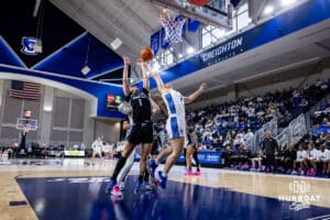 Creighton Bluejay guard Kennedy Townsend (2) reaches for the ball against Georgetown Hoya guard Kelsey Ransom (1) in the first quarter during a college basketball game Saturday, February 15, 2025 in Omaha, Nebraska. Photo by John S. Peterson.