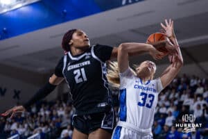 Creighton Bluejay guard Brooke Littrell (33) draws a foul from Georgetown Hoya center Ariel Jenkins (21) in the first quarter during a college basketball game Saturday, February 15, 2025 in Omaha, Nebraska. Photo by John S. Peterson.