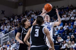 Creighton Bluejay guard Lauren Jensen (15) takes a shot against Georgetown Hoya guard Kelsey Ransom (1) and guard Victoria Rivera (3) in the first quarter during a college basketball game Saturday, February 15, 2025 in Omaha, Nebraska. Photo by John S. Peterson.