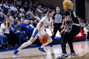 Creighton Bluejay guard Lauren Jensen (15) dribbles the ball against Georgetown Hoya guard Khadee Hession (8) in the first quarter during a college basketball game Saturday, February 15, 2025 in Omaha, Nebraska. Photo by John S. Peterson.