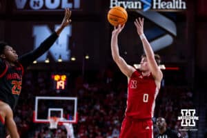 Nebraska Cornhusker guard Connor Essegian (0) makes a three-point shot against Maryland Terrapin center Derik Queen (25) in the first half during a college basketball game Thursday, February 13, 2025 in Lincoln, Nebraska. Photo by John S. Peterson.
