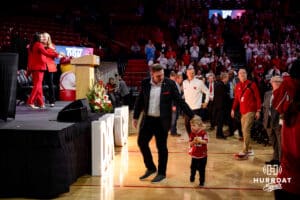 Husband of Nebraska volleyball coach Dani Busboom-Kelly, Land Kelly, and son their son Boone make their way to the stage during the Welcome to Dani Busboom-Kelly Celebration event Thursday, February 6, 2025, in Lincoln, Nebraska. Photo by John S. Peterson.