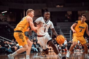 Omaha Maverick JJ White dribbles past defender against the North Dakota State Bison during a college basketball game on Saturday, February 8, 2025 in Omaha, Nebraska. Photo by Logan Hock.