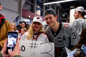 Omaha Maverick Sam Stange taking a picture with a fan during a hockey match at Baxter Arena on Saturday, February 2, 2025, in Omaha, Nebraska. Photo by Collin Stilen.