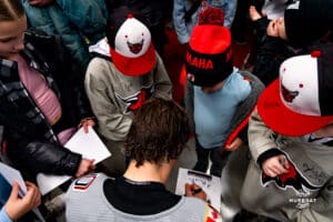 Omaha Maverick Jacob Guevin signing autographs for the fans during a hockey match at Baxter Arena on Saturday, February 2, 2025, in Omaha, Nebraska. Photo by Collin Stilen.