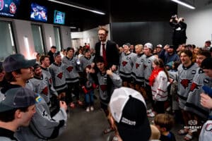 Omaha Mavericks gather in a circle to sing their anthem during a hockey match at Baxter Arena on Saturday, February 2, 2025, in Omaha, Nebraska. Photo by Collin Stilen.