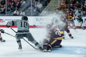 Omaha Maverick Jacob Guevin fights for the puck during a hockey match at Baxter Arena on Saturday, February 2, 2025, in Omaha, Nebraska. Photo by Collin Stilen.