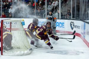 Omaha Maverick Sam Stange shakes two defenders off their tracks during a hockey match at Baxter Arena on Saturday, February 2, 2025, in Omaha, Nebraska. Photo by Collin Stilen.