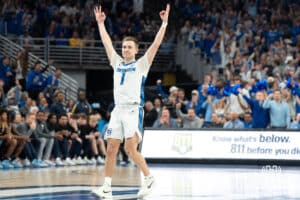 Creighton Bluejays Steven Ashworth celebrates Ryan Kalkbrenner’s three-point shot during a college basketball game against Marquette on February 8th, 2025 in Omaha, Nebraska. Photo by Brandon Tiedemann.