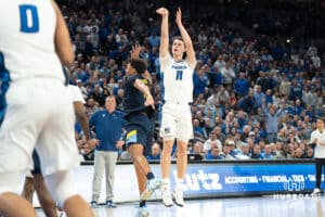 Creighton Bluejays Ryan Kalkbrenner shoots a three pointer during a college basketball game against Marquette on February 8th, 2025 in Omaha, Nebraska. Photo by Brandon Tiedemann.