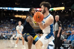 Creighton Bluejays Fedor Žugić looks to passduring a college basketball game against Marquette on February 8th, 2025 in Omaha, Nebraska. Photo by Brandon Tiedemann.