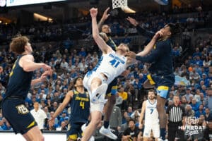 Creighton Bluejays Isaac Traudt gets fouled on a layup during a college basketball game against Marquette on February 8th, 2025 in Omaha, Nebraska. Photo by Brandon Tiedemann.