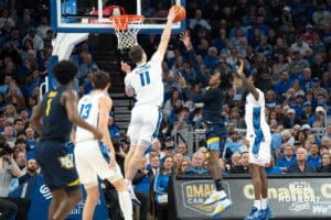 Creighton Bluejays Ryan Kalkbrenner blocks a layup during a college basketball game against Marquette on February 8th, 2025 in Omaha, Nebraska. Photo by Brandon Tiedemann.
