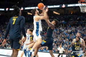 Creighton Bluejays Fedor Žugić attempts a layup during a college basketball game against Marquette on February 8th, 2025 in Omaha, Nebraska. Photo by Brandon Tiedemann.