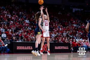 Nebraska Cornhuskers guard Britt Prince (23) makes a three-point shot against Michigan Wolverines guard Syla Swords (12) in the second quarter during a college women’s basketball game on Wednesday, February 6, 2025 in Lincoln, Nebraska. Photo by John S. Peterson.