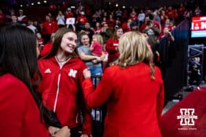 Nebraska head volleyball coach Dan Busboom-Kelly stops and talks to volleyball teammate Bergan Reilly during a college women’s basketball game against the Michigan Wolverines on Wednesday, February 6, 2025 in Lincoln, Nebraska. Photo by John S. Peterson.