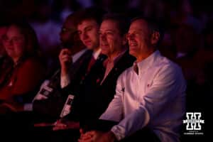 Retiring Nebraska volleyball coach John Cook listening to Dani Busboom-Kelly speak with Nebraska Govenor Jim Pillen during the Welcome to Dani Busboom-Kelly Celebration event Thursday, February 6, 2025 in Lincoln, Nebraska. Photo by John S. Peterson.