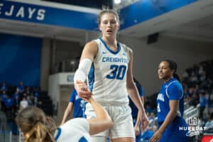 Creighton Bluejays Morgan Maly helps a teammate up during a college basketball game against Seton Hall on February 5th, 2025 in Omaha Nebraska. Photo by Brandon Tiedemann.