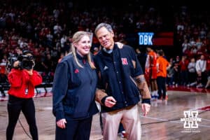 Nebraska Cornhuskers incoming volleyball coach Dani Busboom-Kelly and retiring volleyball John Cook wave to the fans during a college basketball game Illinois Fighting Illini, Thursday, January 30, 2025, in Lincoln, Nebraska. Photo by John S. Peterson.
