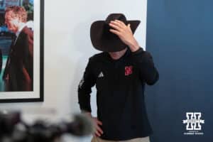 Nebraska Volleyball head coach John Cook bows with a cowboy hat during the press conference announce his retirement to the media on January 30th, 2025, in Lincoln Nebraska. Photo by Brandon Tiedemann.