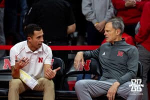 Nebraska Cornhuskers head coach John Cook talking with assistant Jaylen Reyes against the Florida A&M Rattlers during the first round of the NCAA volleyball tournament Friday, December 6, 2024, in Lincoln, Nebraska. Photo by John S. Peterson.