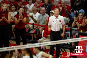 Nebraska Cornhusker head coach John Cook gives a fist pump after a big score against the Creighton Bluejays in the during the college volleyball match Tuesday, September 10, 2024, in Lincoln, Nebraska. Photo John S. Peterson.