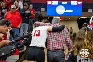 Nebraska Cornhusker Merritt Beason (13) and head coach John Cook head back to the lockerroom after the win over the Arkansas Razorbacks during the third round in the NCAA Volleyball Championship match on Saturday, December 9, 2023, Lincoln, Neb. Photo by John S. Peterson.