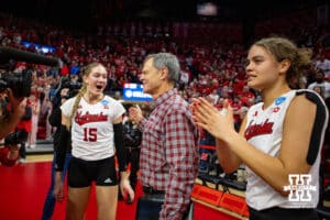 Nebraska Cornhuskers Andi Jackson (15), John Cook, and Bekka Allick (5) celebrate the win over the Arkansas Razorbacks during the Regional Championship match in the NCAA Volleyball Championship Thursday, December 7, 2023, Lincoln, Neb. Photo by John S. Peterson.