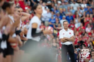 Nebraska head coach John Cook watching Merritt Beason wave to the fane during Nebraska Volleyball Day match against Omaha in Lincoln, Nebraska, Wednesday, August 30, 2023. Photo by John Peterson.