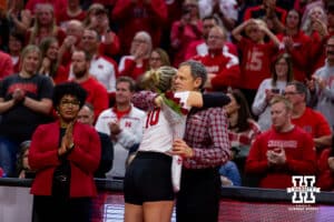Nebraska's Madi Kubik (10) recieves a hug from coach John Cook after the college volleyball match against the Minnesota Golden Gophers Saturday, November 26, 2022, in Lincoln, Nebraska. Photo by John S. Peterson.