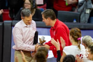 Nebraska Cornhuskers athletic director Trev Alberts awards head coach John Cook with a trophy recognizing his 800th win during a college volleyball match against the Michigan State Spartans September 23, 2022, in Lincoln, Neb. Photo by John S. Peterson.