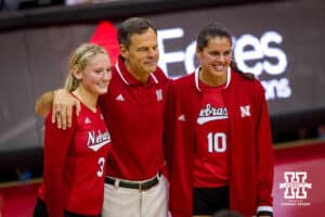 August 29, 2015: Nebraska head coach John Cook recognized for his 600 win and was presented a ball by Kelly Hunter #3 and Alicia Ostrander #10 after the match against Pittsburgh during the Nebraska Invite at the Devaney Sports Center in Lincoln, Nebraska. Nebraska 3 Pittsburgh 1.