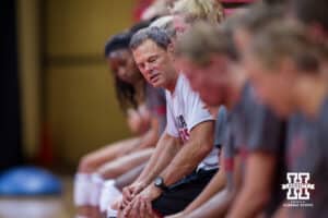 August 10, 2015: Head coach John Cook leading warm-ups as the team does chair squats during practice at the Devaney Sports Center in Lincoln, Nebraska.
