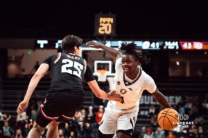 UNO Mavericks player, JJ White, dribbles past Denver opponent during a college basketball game on Feb 01, 2025 in Omaha, Nebraska. Photo by Logan Hock