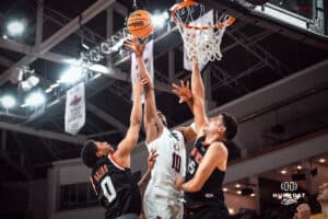 UNO Mavericks player, Marquel Sutton, takes a shot over Denver opponents during a college basketball game on Feb 01, 2025 in Omaha, Nebraska. Photo by Logan Hock