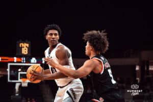 UNO Mavericks player, Marquel Sutton, faces off against Denver opponent during a college basketball game on Feb 01, 2025 in Omaha, Nebraska. Photo by Logan Hock.