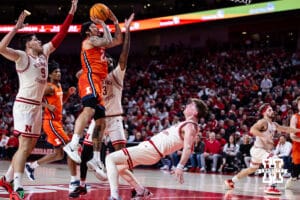 Nebraska Cornhuskers guard Connor Essegian (0) gets fouled by Illinois Fighting Illini guard Tre White (22) for charging in the first half during a college basketball game, Thursday, January 30, 2025, in Lincoln, Nebraska. Photo by John S. Peterson.