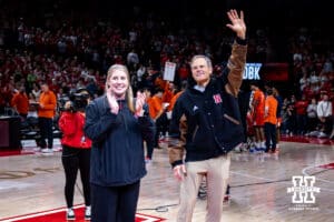 Nebraska Cornhuskers incoming volleyball coach Dani Busboom-Kelly and retiring volleyball John Cook wave to the fans during a college basketball game Illinois Fighting Illini, Thursday, January 30, 2025, in Lincoln, Nebraska. Photo by John S. Peterson.