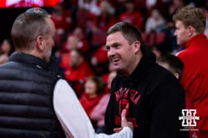 Former Nebraska quarterback and Cinninati Begals head coach Zack Taylor catching up with Nebraska photographer Scott Bruhn before the basketball game against the Illinois Fighting Illini, Thursday, January 30, 2025, in Lincoln, Nebraska. Photo by John S. Peterson.