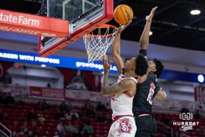 Omaha Mavericks forward Marquel Sutton (10) blocks a layup by South Dakota Coyotes guard Dre Bullock (11) in the first half during a college basketball game, Wednesday, January 29, 2025, in Vermillion, South Dakota. Photo by John S. Peterson.
