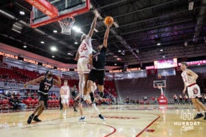 Omaha Mavericks guard Lance Waddles (7) drives to the basket against South Dakota Coyotes forward Ashton Smith (32) in the first half during a college basketball game, Wednesday, January 29, 2025, in Vermillion, South Dakota. Photo by John S. Peterson.