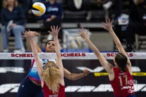 Omaha Supernova Kayla Caffey (28) spikes the ball against Grand Rapids Rise Carli Snyder (4) and Alyssa Jensen (17) during a professional