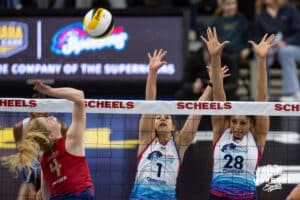 Omaha Supernova Natalia Valentin-Anderson (1) and Omaha Supernova Kayla Caffey (28) jump up to defend against Grand Rapids Rise Carli Snyder (4) during a professional volleyball match Sunday, March 30, 2025 in Omaha, Nebraska. Photo by John S. Peterson.