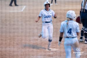 Creighton Bluejays Lily West steps on home during a college softball game against UCONN on March 28th, 2025 in Omaha, Nebraska. Photo by Brandon Tiedemann.