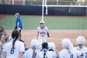 Creighton Bluejays Sydra Seville celebrates a grand slam during a college softball game against UCONN on March 28th, 2025 in Omaha, Nebraska. Photo by Brandon Tiedemann.