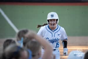 Creighton Bluejays Avery Barnard celebrates a home run during a college softball game against UCONN on March 28th, 2025 in Omaha, Nebraska. Photo by Brandon Tiedemann.