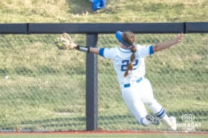 Creighton Bluejays Hannah Poole makes a diving catch during a college softball game against UCONN on March 28th, 2025 in Omaha, Nebraska. Photo by Brandon Tiedemann.
