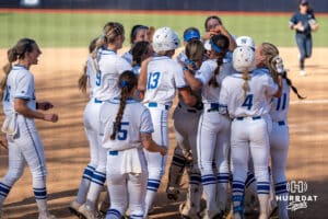 Creighton Bluejays celebrate a walk off win during a college softball game against UCONN on March 28th, 2025 in Omaha, Nebraska. Photo by Brandon Tiedemann.