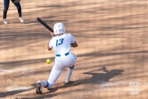 Creighton Bluejays Ella Dalton bunts during a college softball game against UCONN on March 28th, 2025 in Omaha, Nebraska. Photo by Brandon Tiedemann.